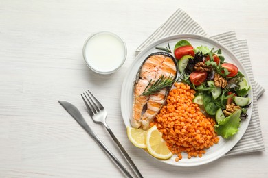 Photo of Plate with healthy food high in vegetable fats served on light wooden table, flat lay. Space for text