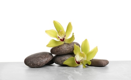 Photo of Orchid flowers with spa stones on white background