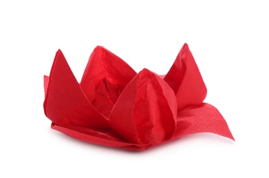 Beautiful origami flower made of red napkin on white background