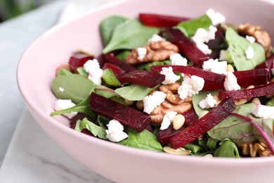 Photo of Delicious beet salad served on table, closeup