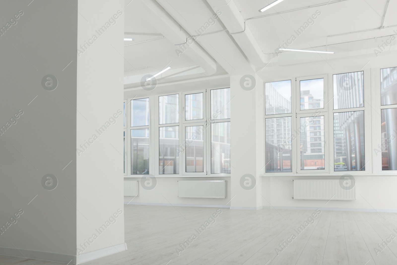 Photo of Modern office room with white walls and windows. Interior design