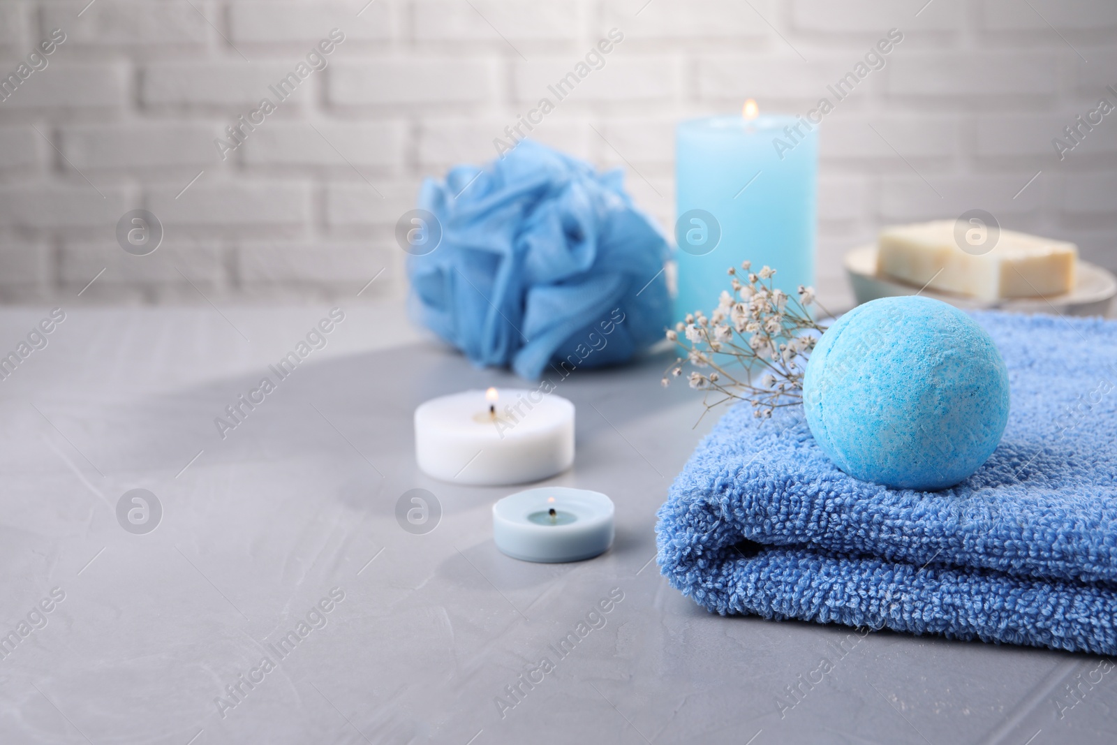 Photo of Beautiful composition with aromatic bath bomb on grey table, space for text