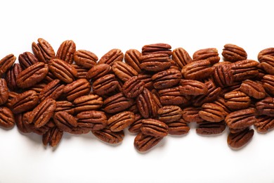 Delicious fresh pecan nuts on white background, flat lay