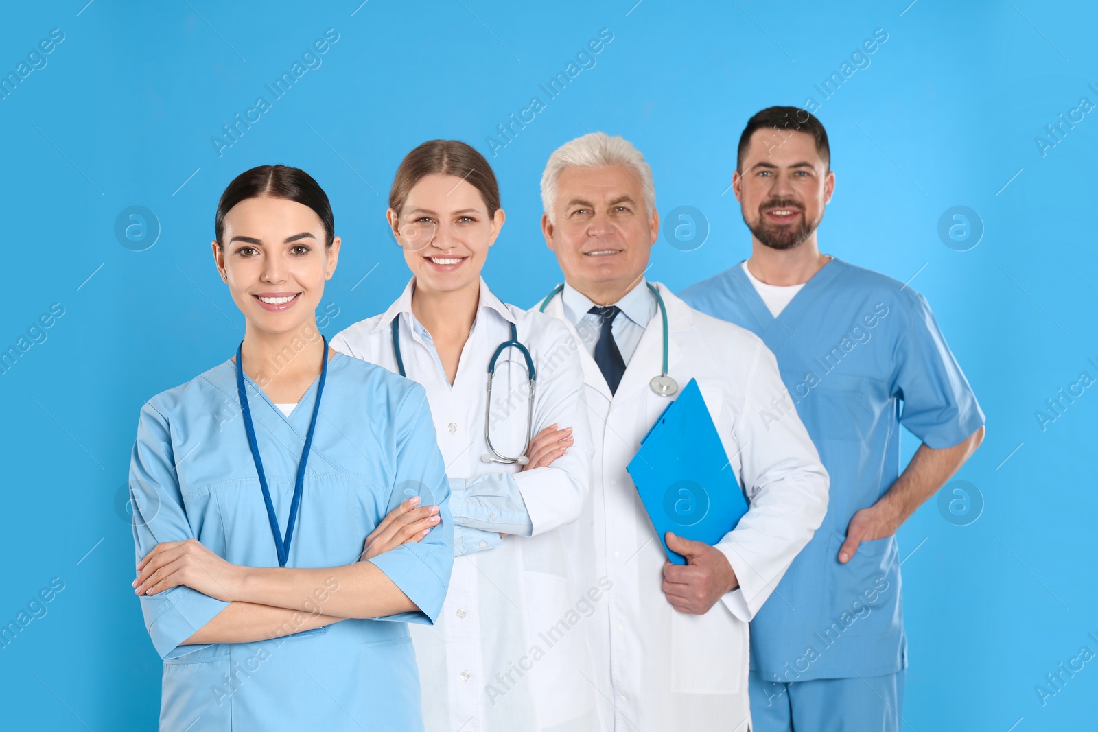 Photo of Group of doctors against blue background. Medical service