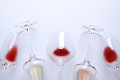 Different glasses with wine on white background, top view