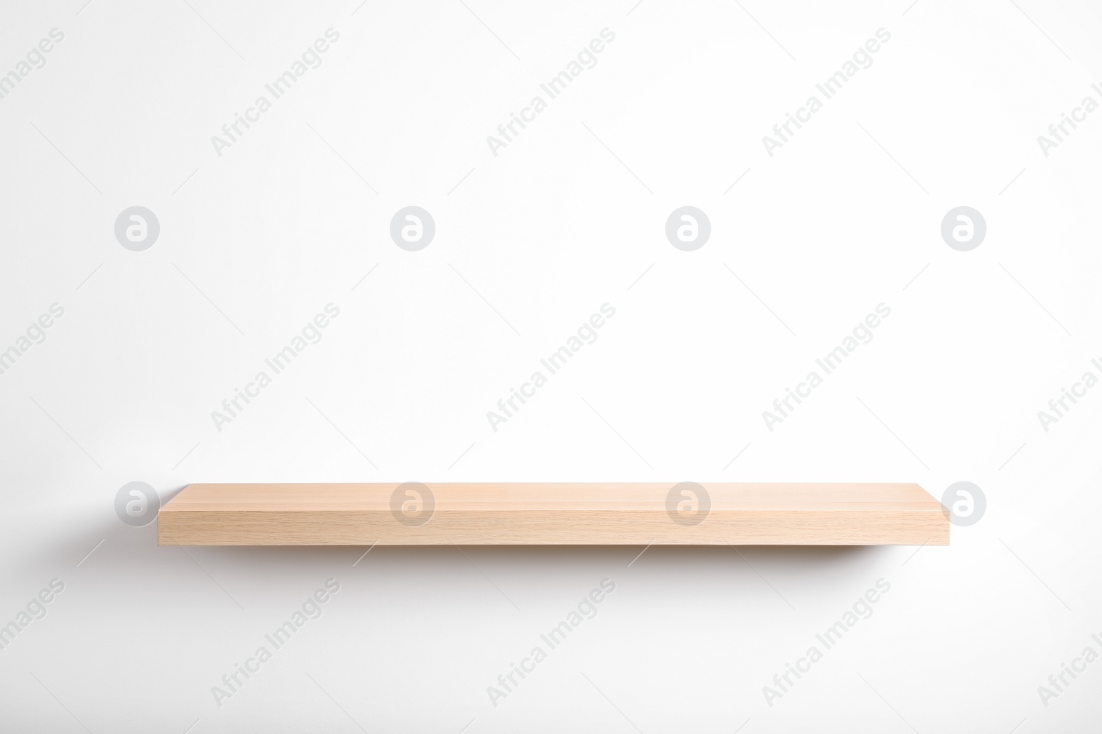 Photo of Empty stylish wooden shelf isolated on white