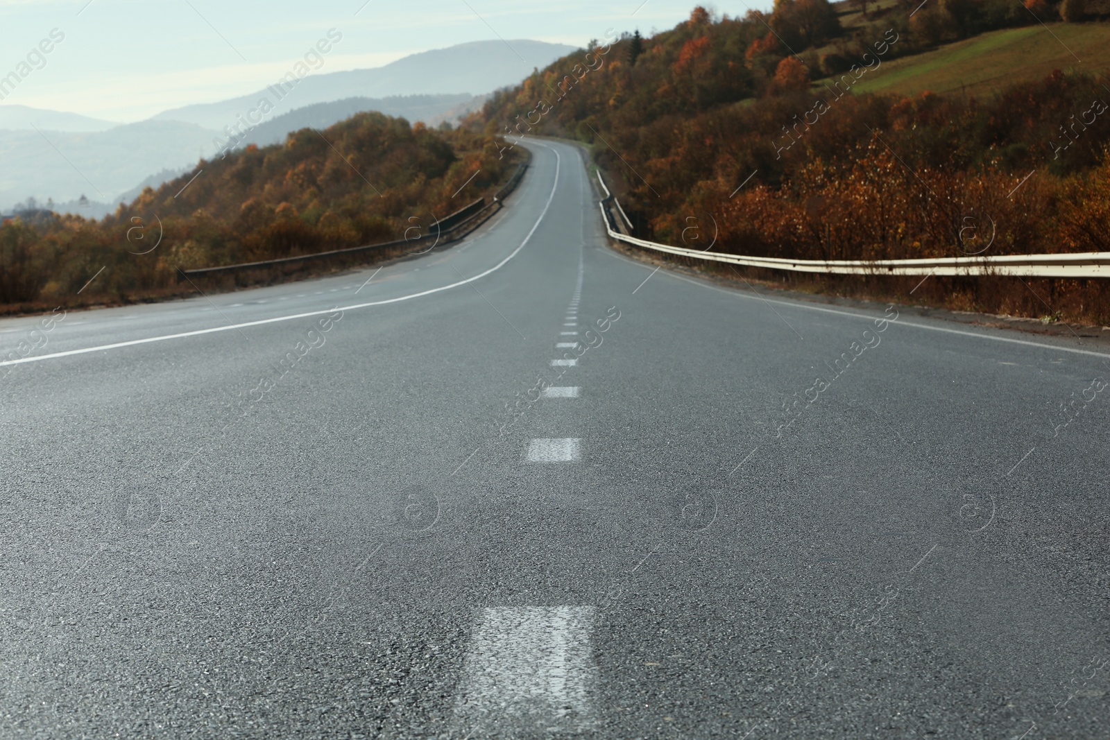 Photo of Landscape with asphalt road leading to mountains