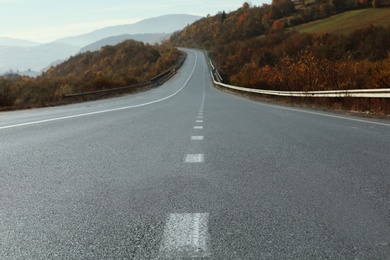 Landscape with asphalt road leading to mountains