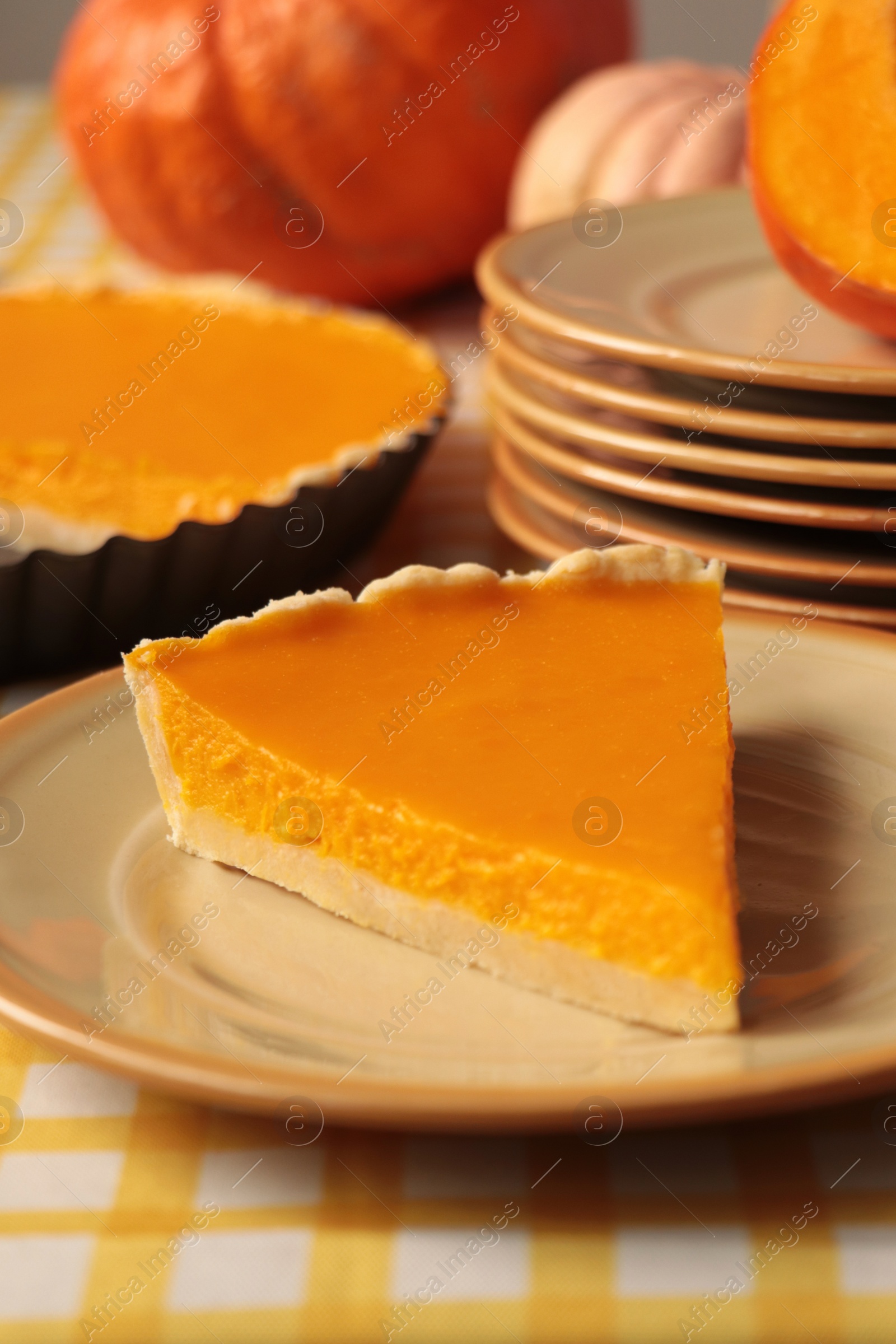 Photo of Plate with piece of fresh homemade pumpkin pie on table