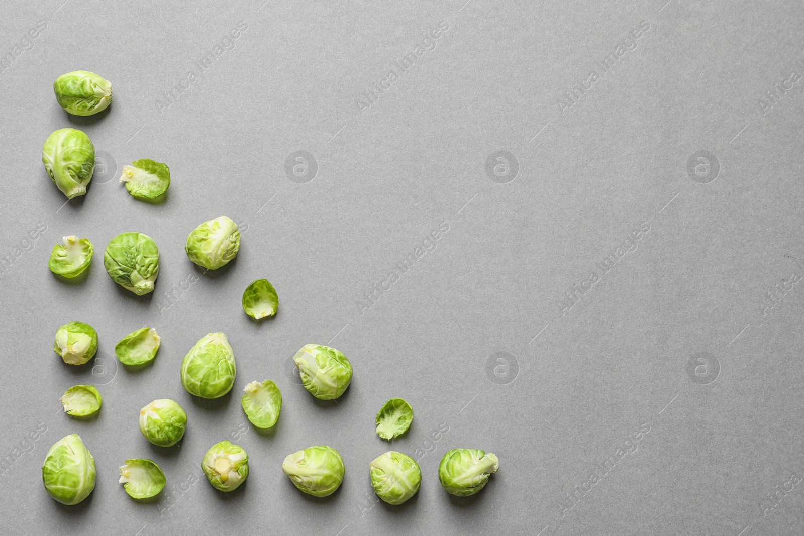 Photo of Tasty fresh Brussels sprouts on grey background, top view with space for text