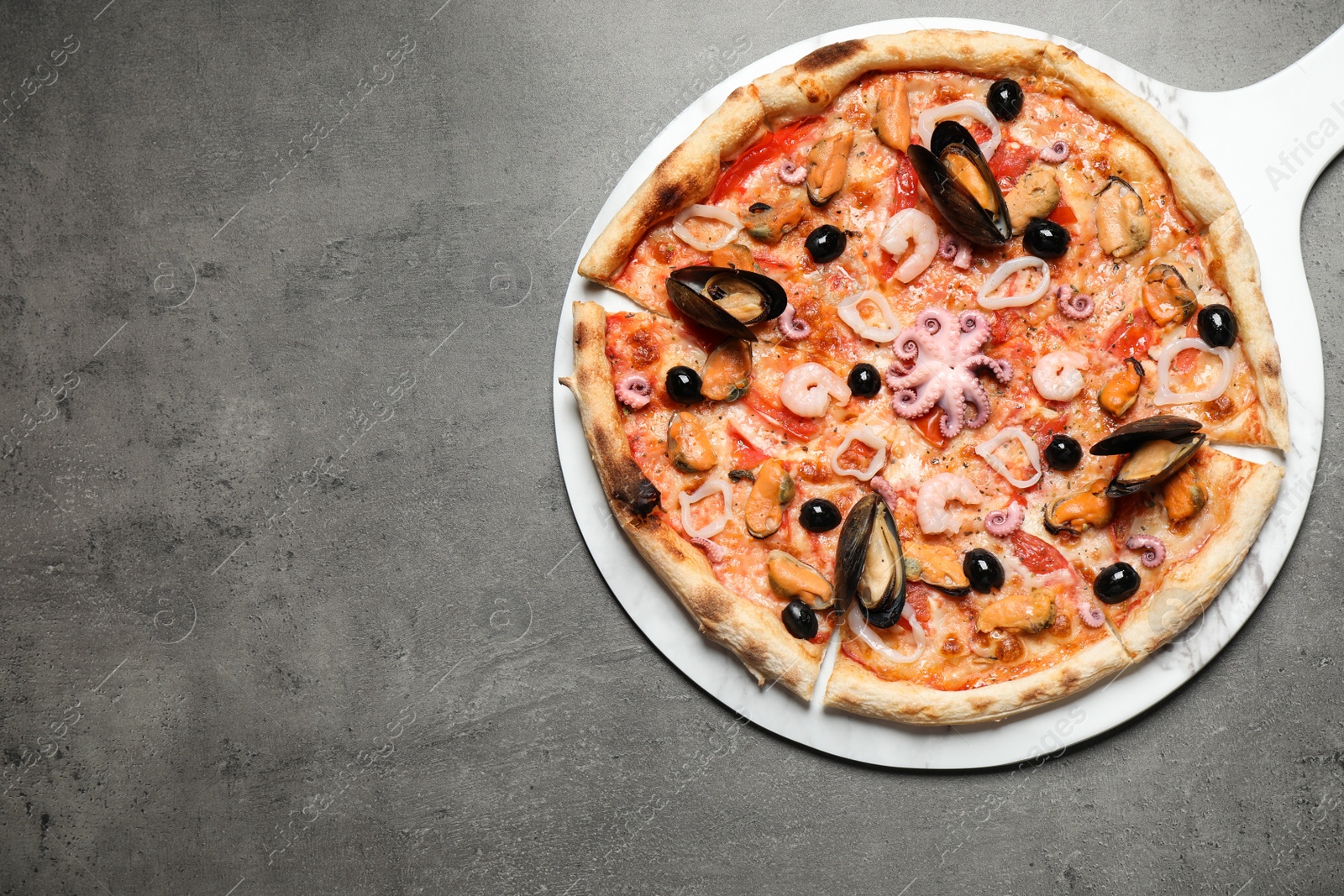 Photo of Delicious seafood pizza on grey table, top view. Space for text