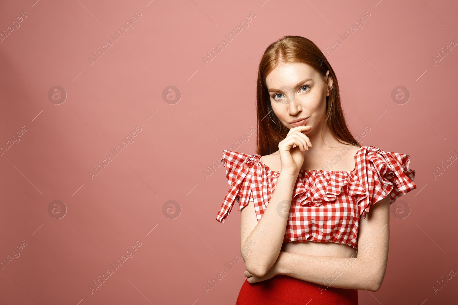 Photo of Portrait of beautiful young woman on pink background, space for text