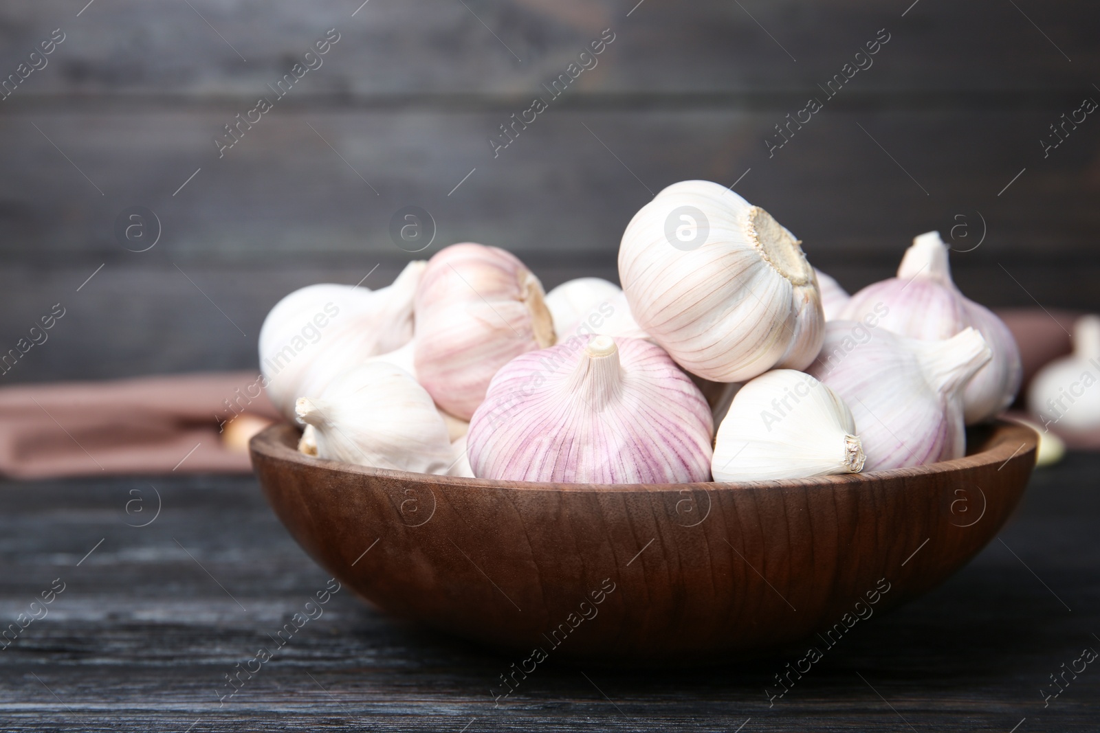 Photo of Plate with fresh garlic bulbs on table