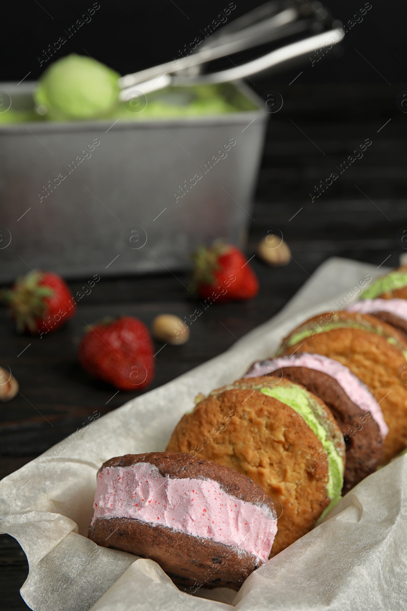 Photo of Different sweet delicious ice cream cookie sandwiches served on table