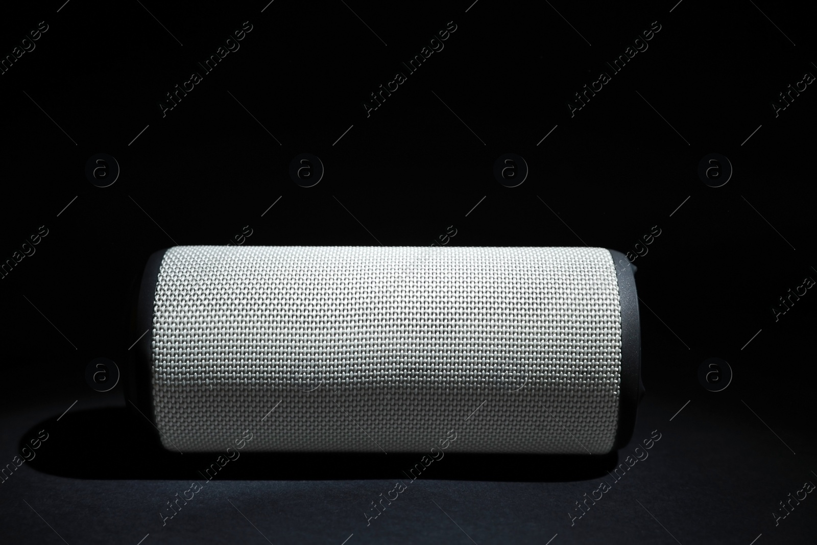 Photo of One portable bluetooth speaker on black background, space for text. Audio equipment