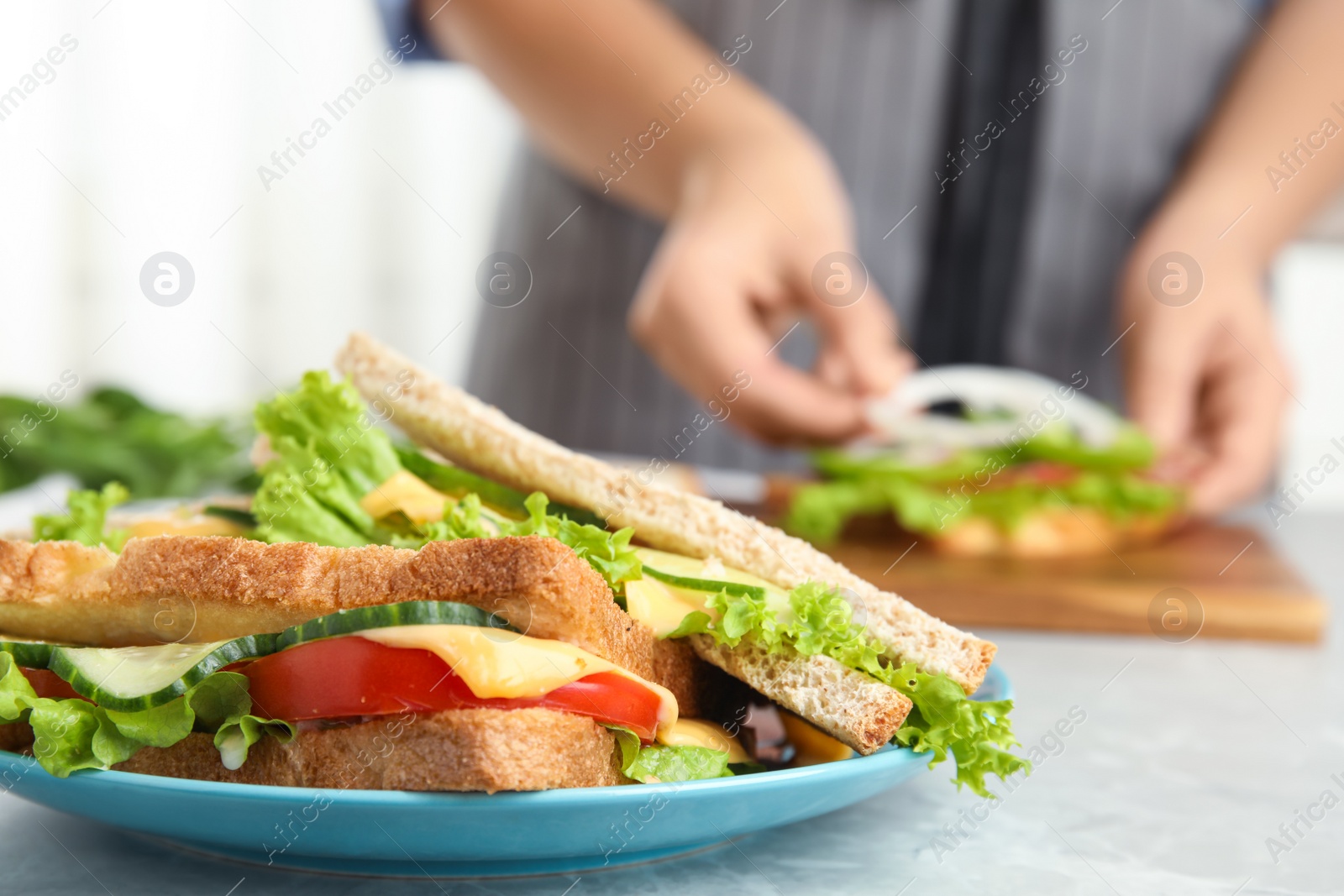 Photo of Tasty sandwiches on light grey marble table, closeup