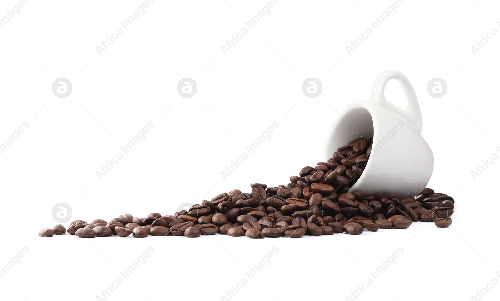 Photo of Coffee beans and overturned cup isolated on white