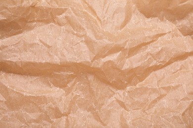 Photo of Texture of crumpled brown baking paper as background, top view