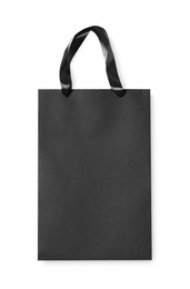 One black paper shopping bag on white background, top view