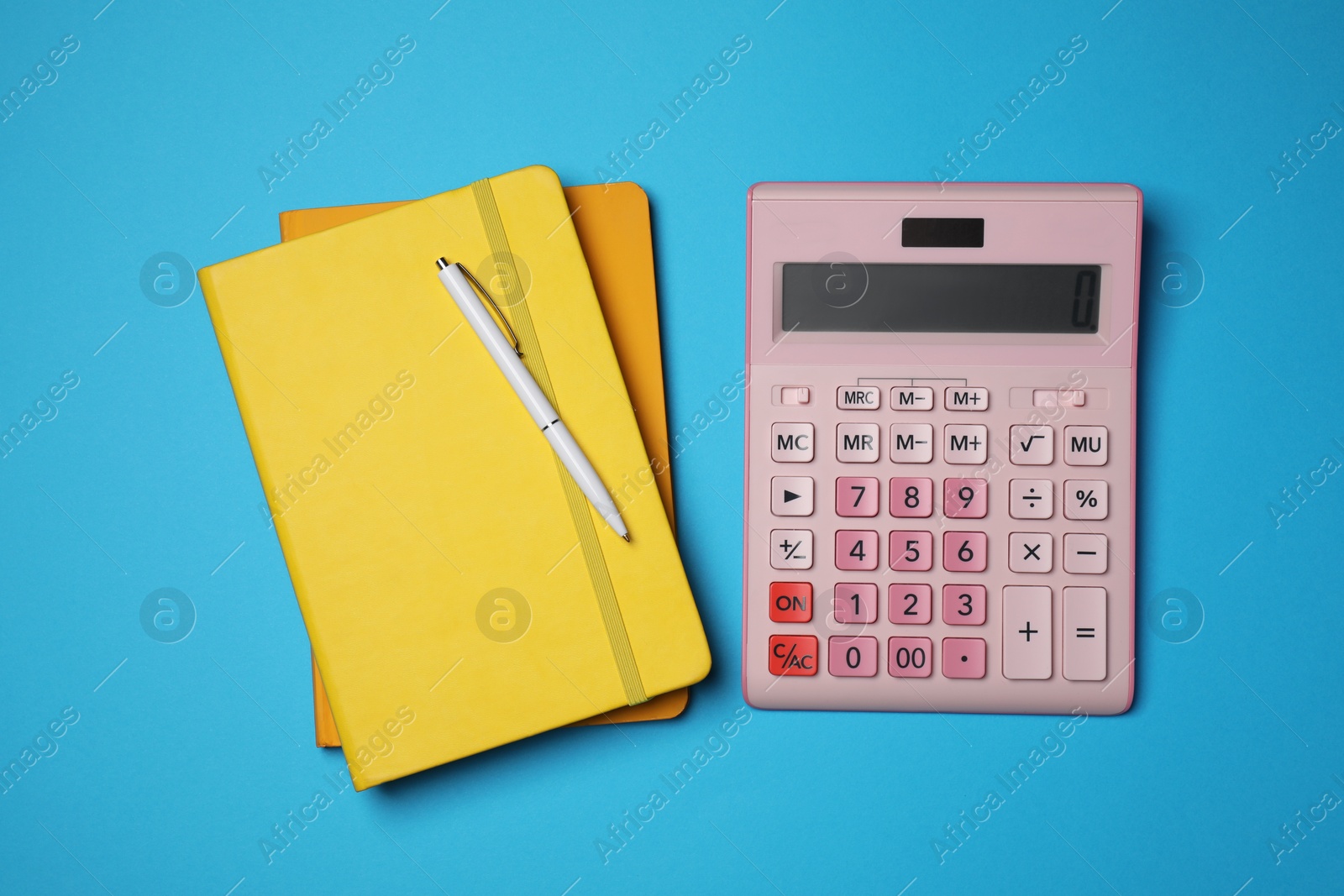 Photo of Calculator, notebooks and pen on light blue background, flat lay