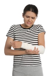 Photo of Young woman with arm wrapped in medical bandage on white background