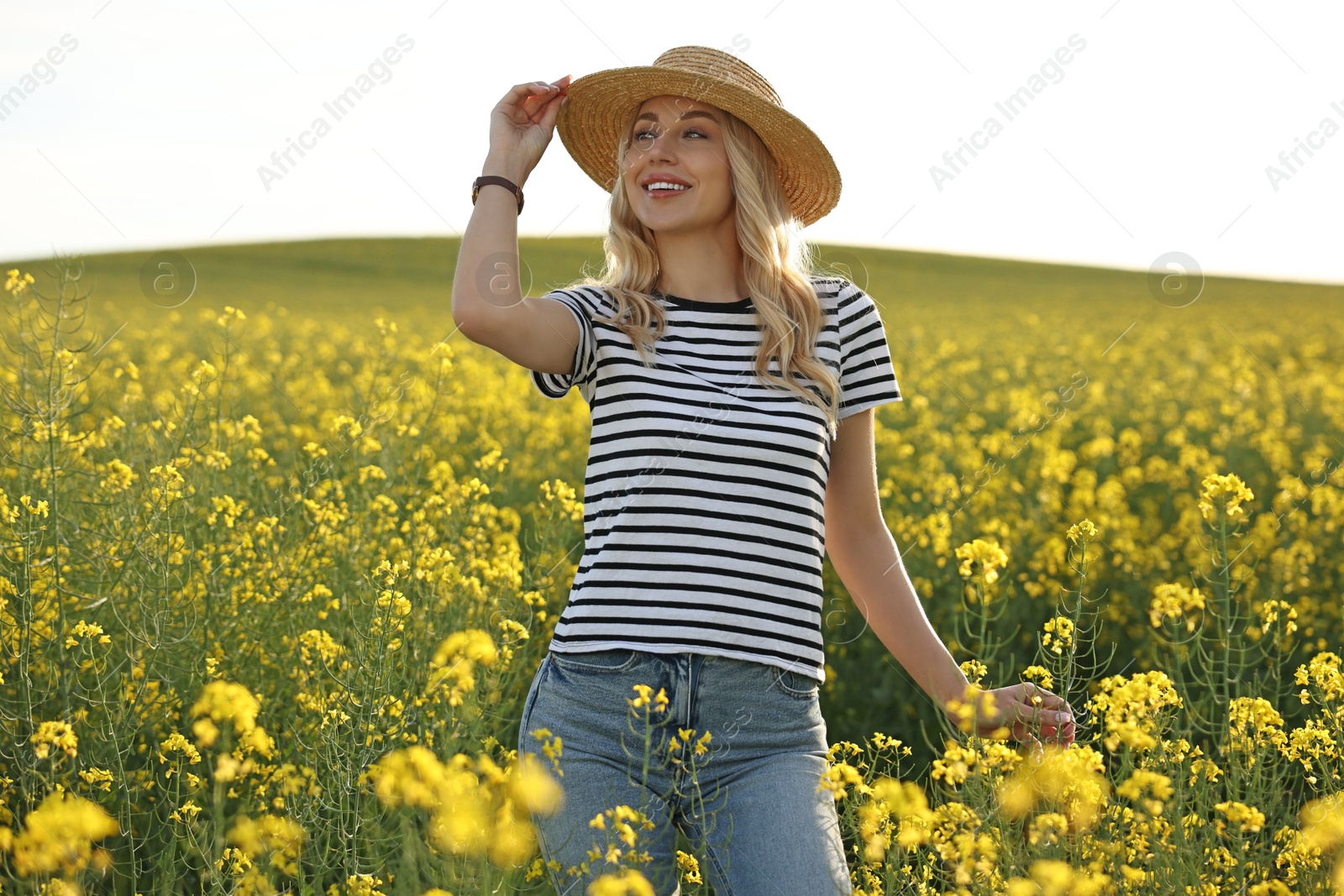 Photo of Happy young woman with straw hat in field on spring day