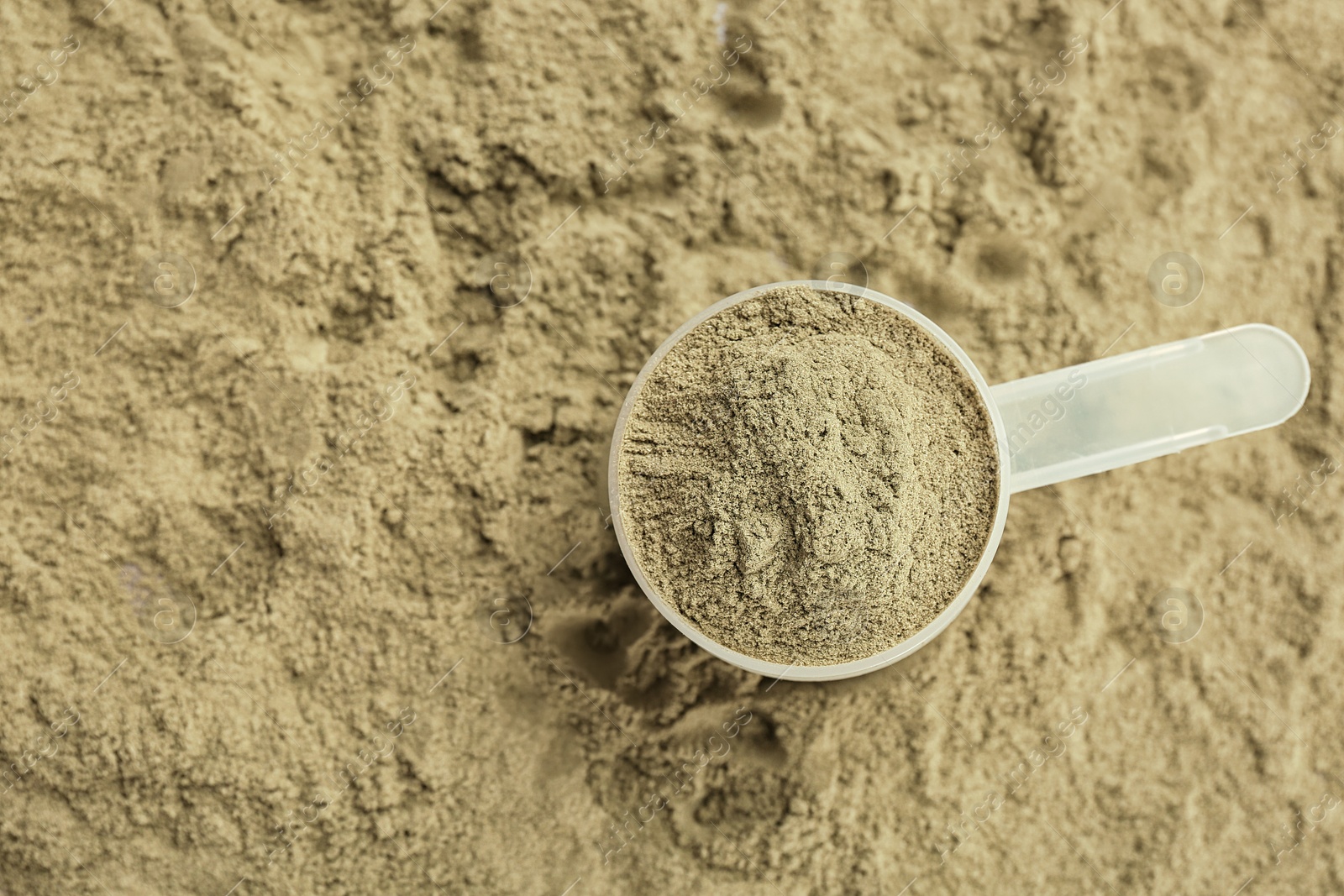 Photo of Measuring spoon and hemp protein powder, top view. Superfood