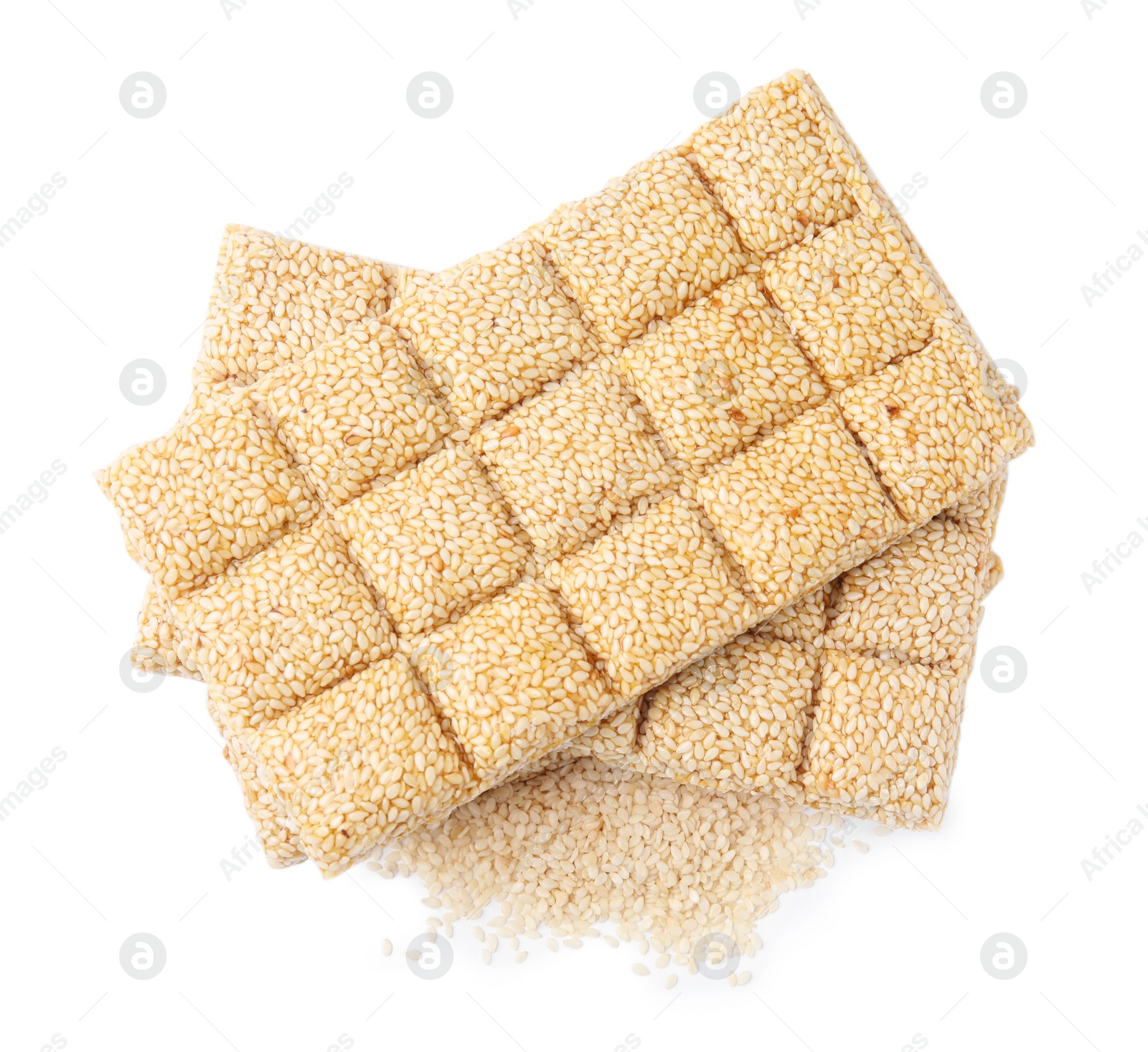 Photo of Tasty sweet kozinaki bars and sesame seeds on white background, top view