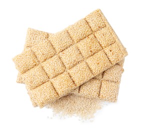 Tasty sweet kozinaki bars and sesame seeds on white background, top view