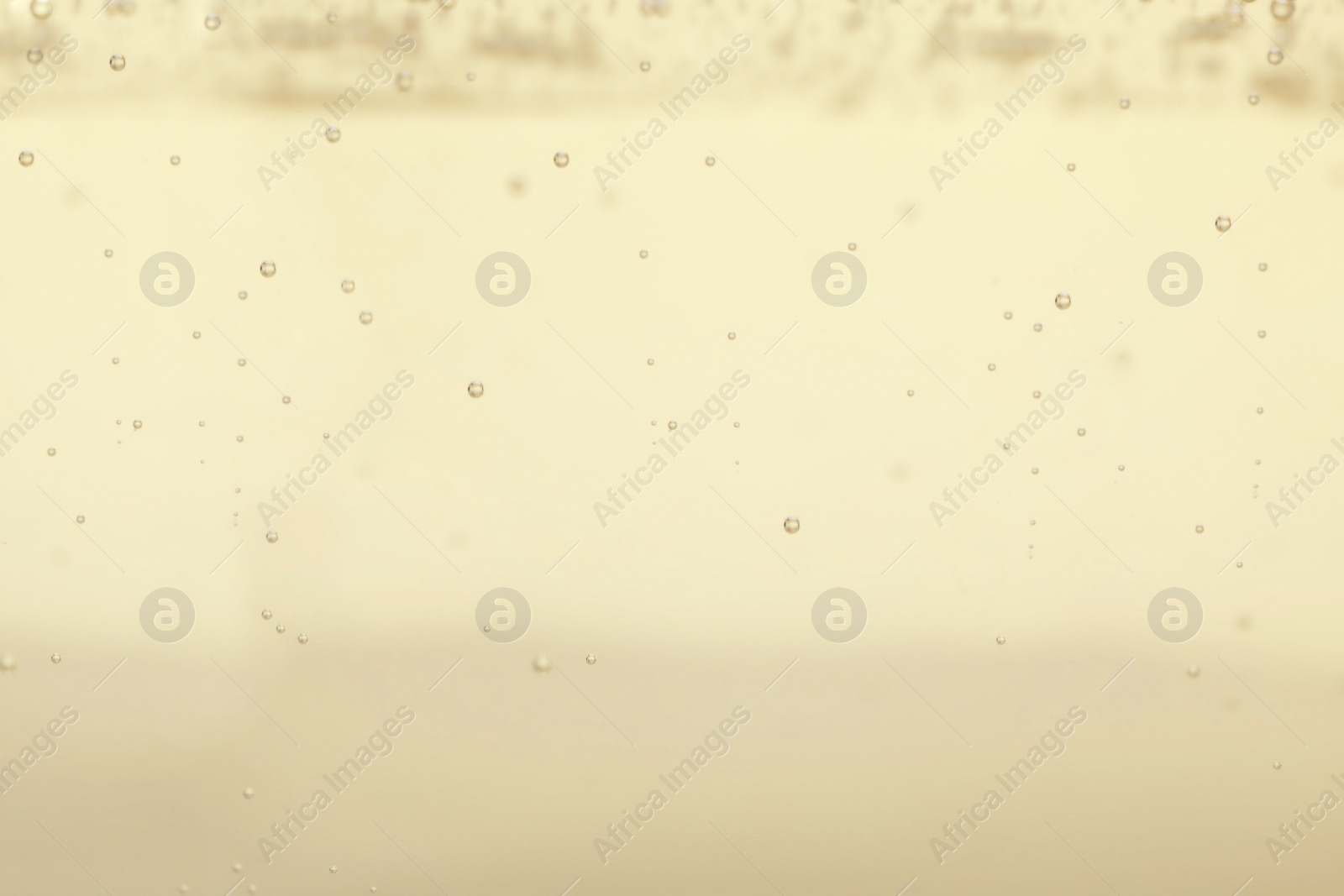 Photo of Closeup view of champagne with bubbles as background