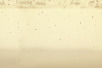 Closeup view of champagne with bubbles as background