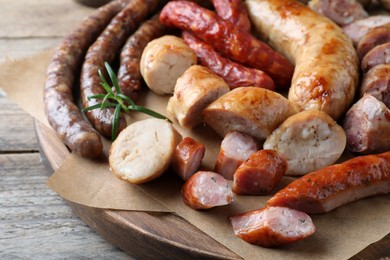 Photo of Set of different tasty snacks on wooden table, closeup view