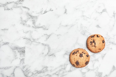 Flat lay composition with chocolate cookies and space for text on marble background