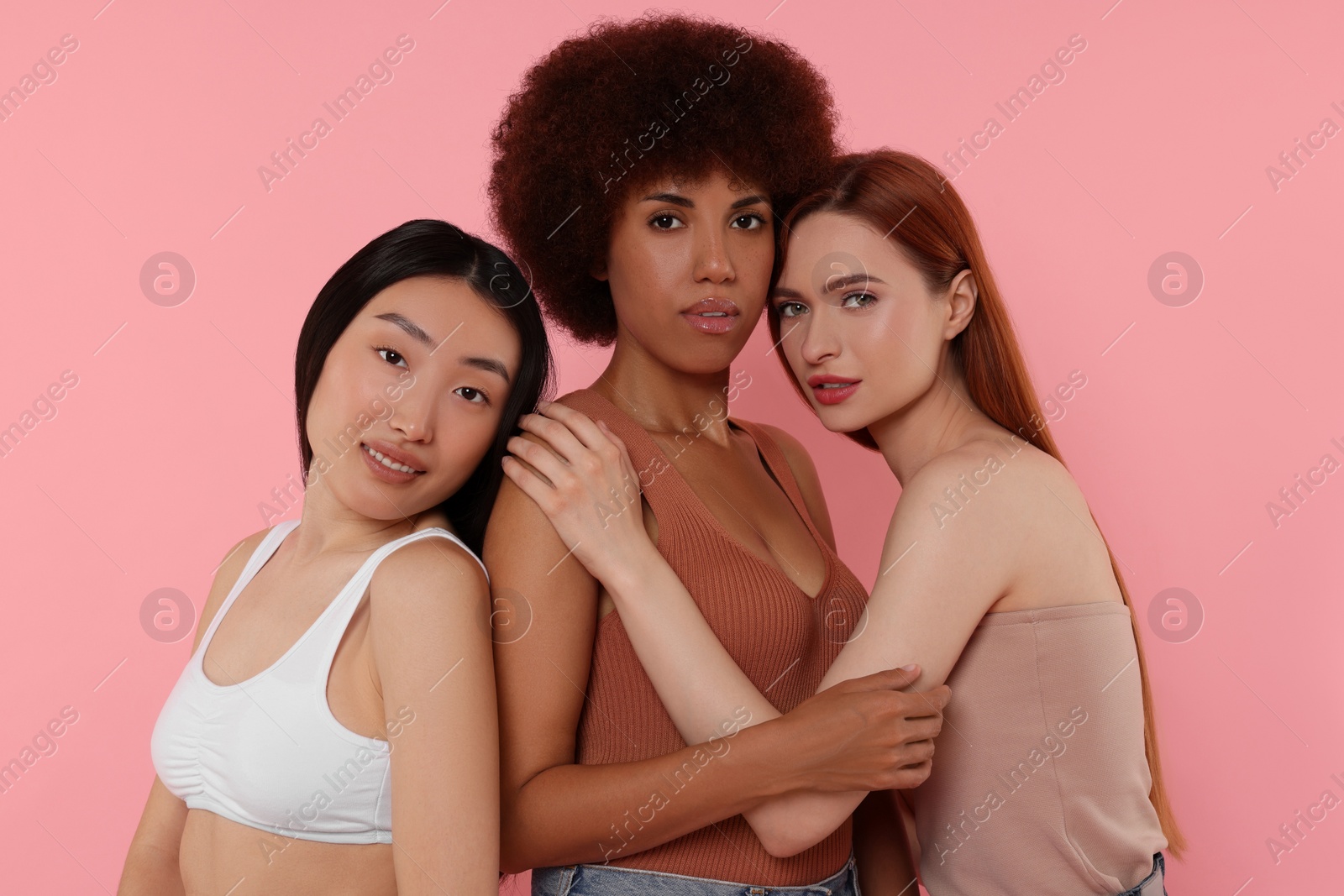 Photo of Portrait of beautiful young women on pink background