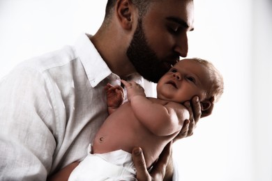 Father with his newborn baby on white background