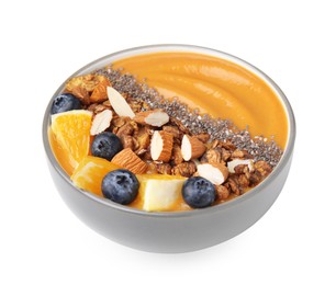 Photo of Bowl of delicious fruit smoothie with fresh orange slices, blueberries and granola isolated on white