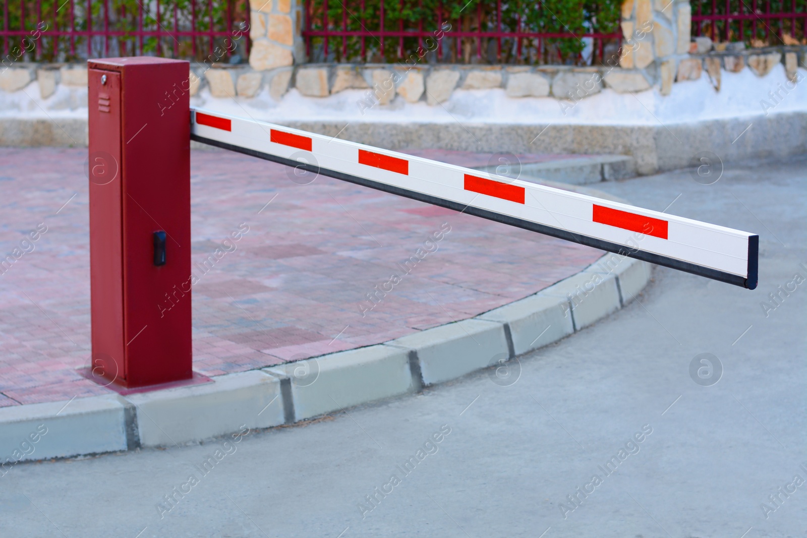 Photo of Closed boom barrier near road on autumn day outdoors