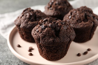 Photo of Delicious fresh chocolate muffins on grey table, closeup