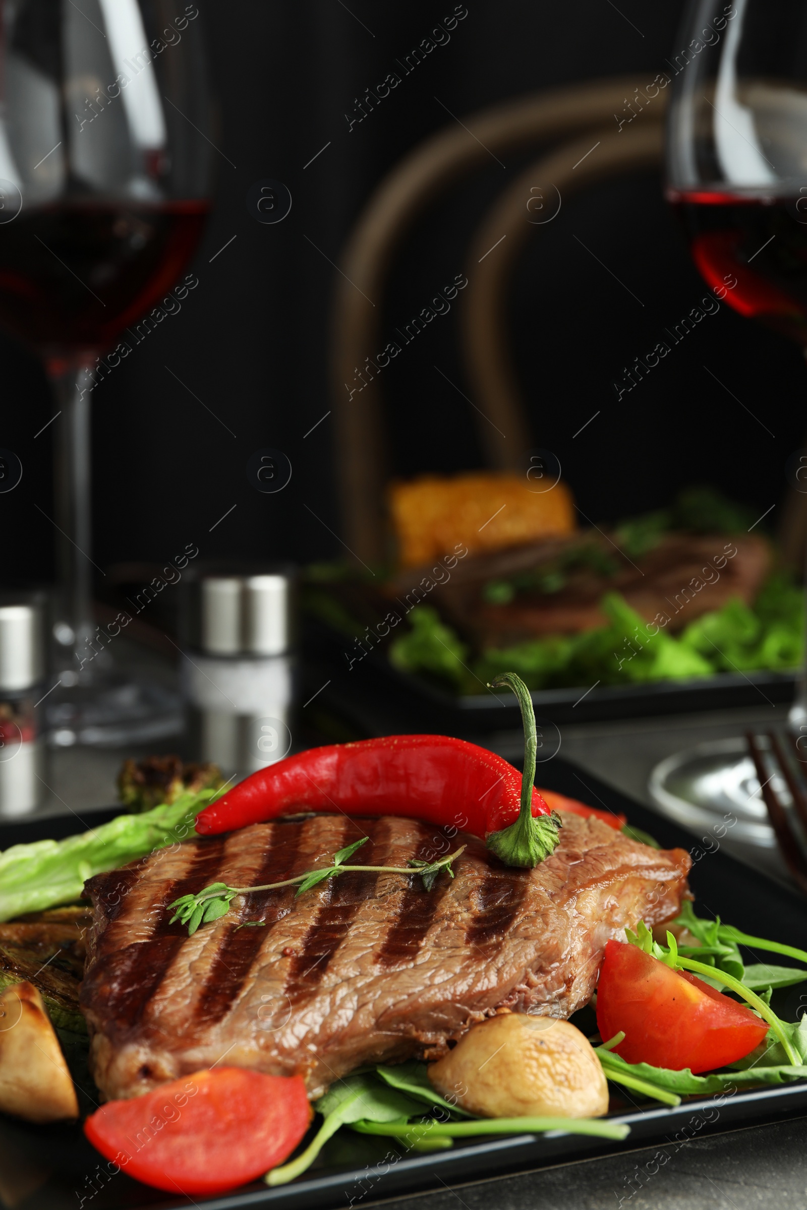 Photo of Delicious beef steak served on table, closeup