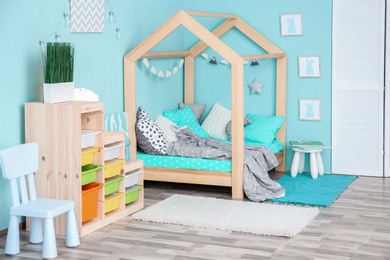 Photo of Comfortable bed in modern children room