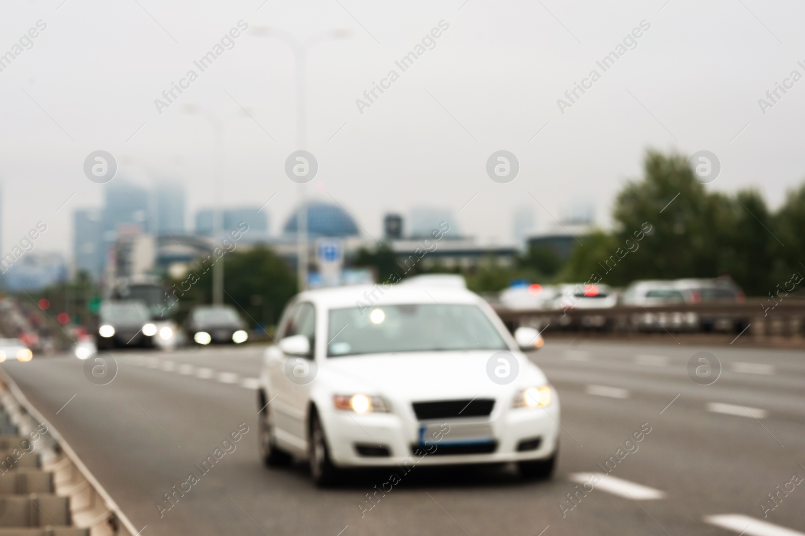 Photo of Blurred view of city road with cars