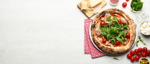 Tasty pizza with meat and arugula on white table, flat lay. Banner design