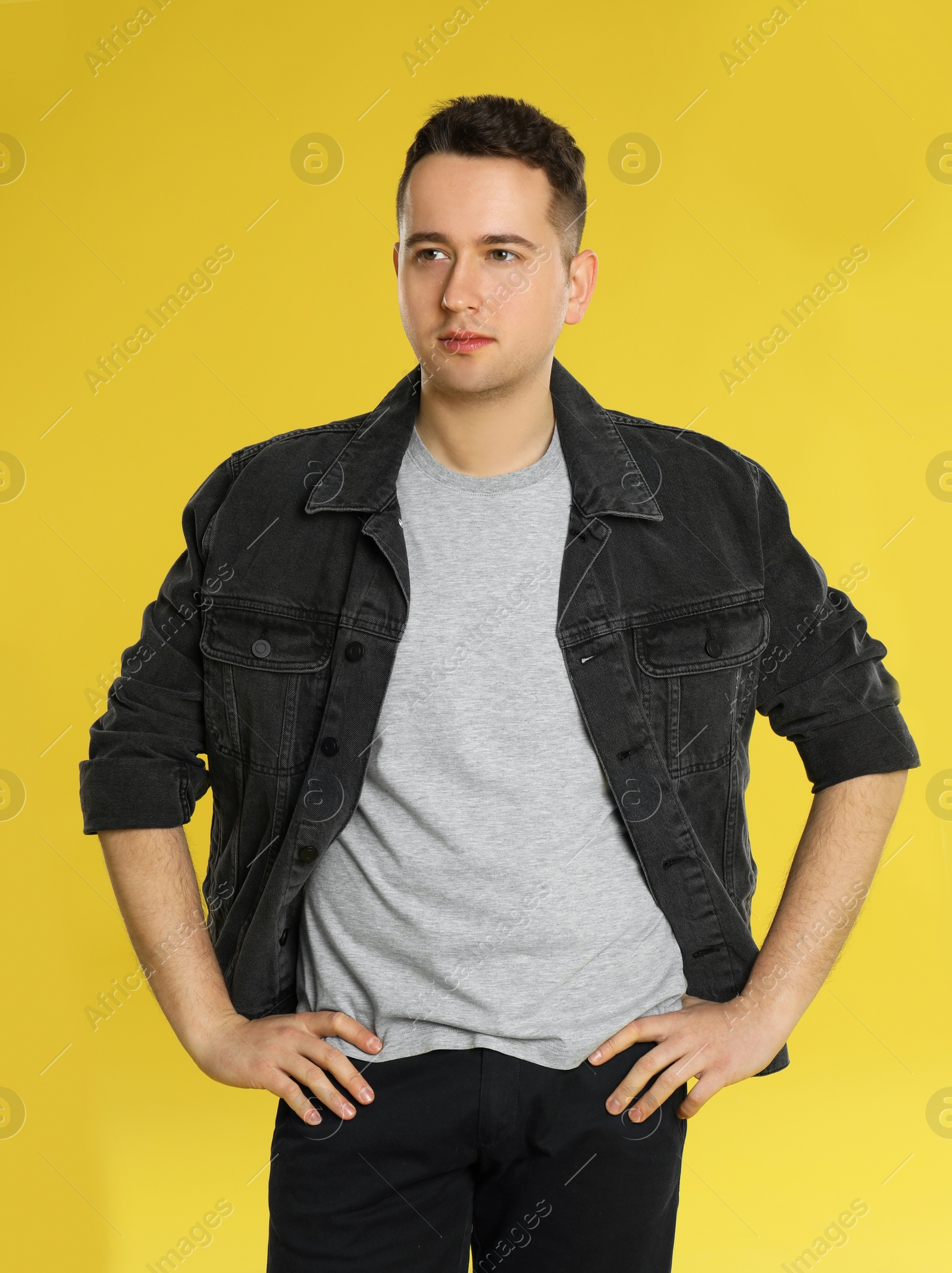 Photo of Portrait of young man on yellow background