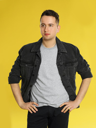 Portrait of young man on yellow background