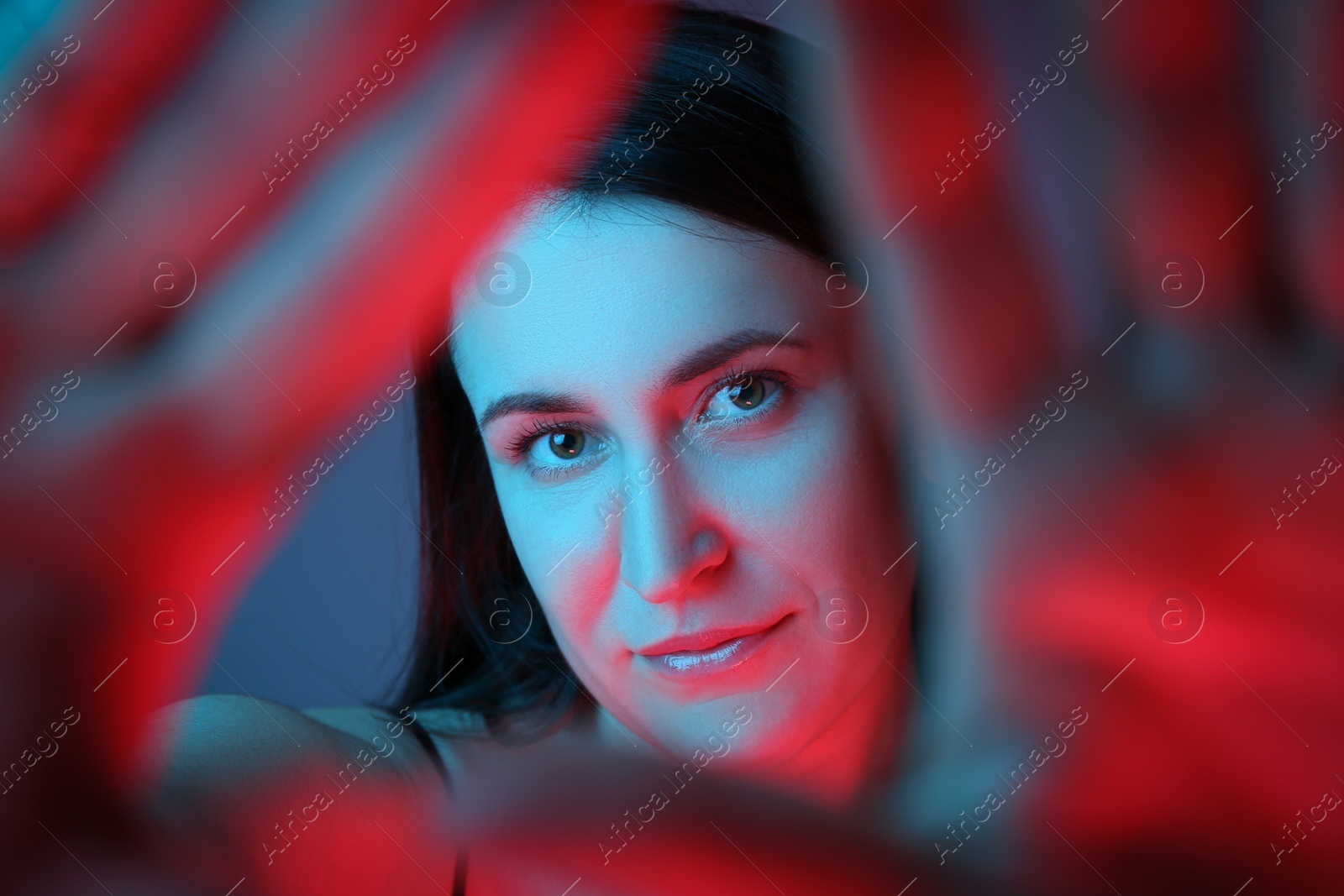 Photo of Beautiful young woman on color background, closeup