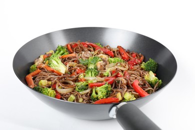 Stir-fry. Tasty noodles with meat and vegetables in wok on white background