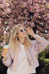 Young woman with icecream in beautiful park