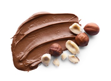 Delicious chocolate paste with hazelnuts on white background, top view