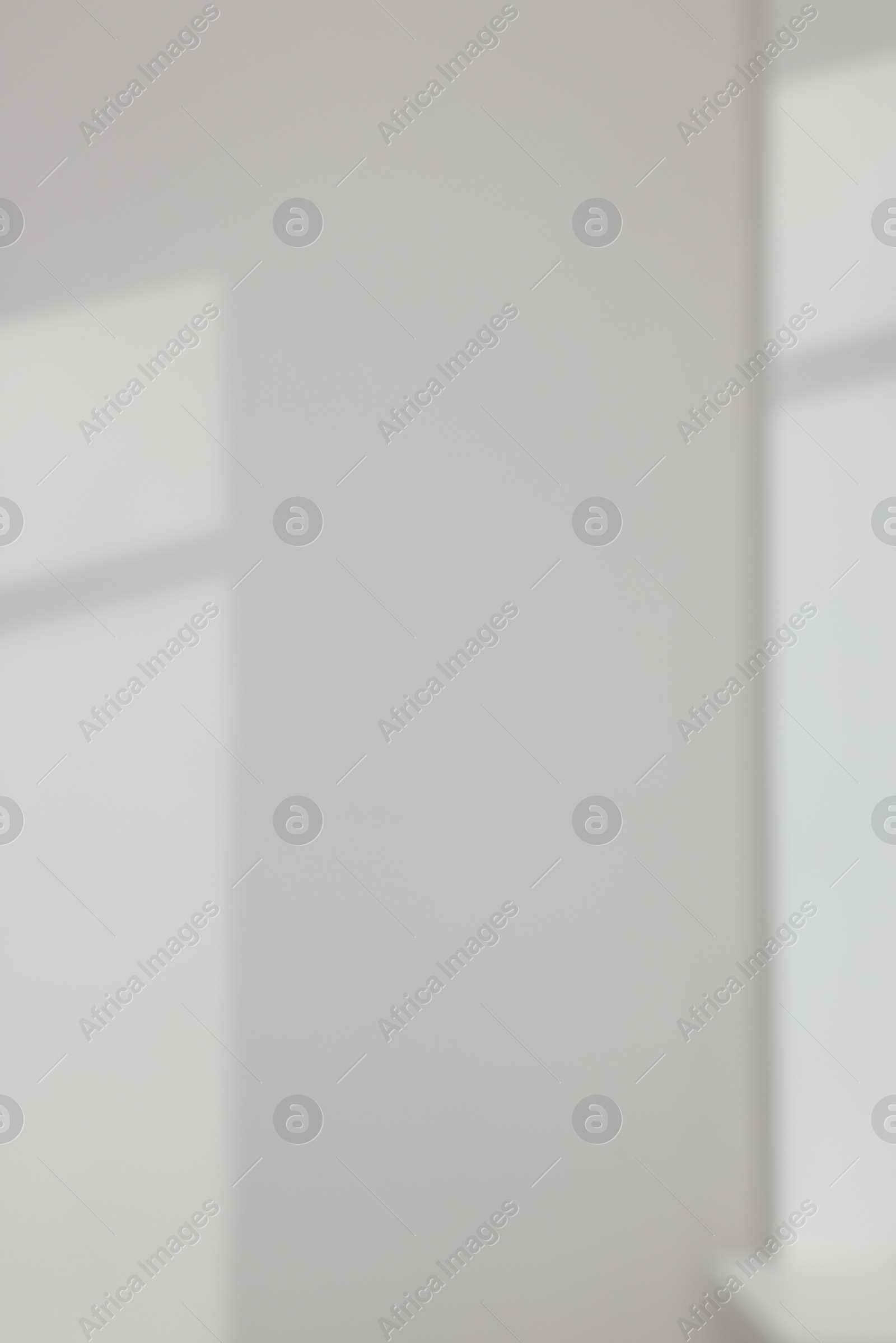 Photo of Light and shadows from window on wall indoors