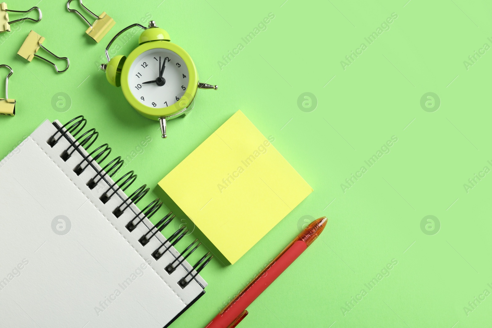 Photo of Modern office accessorises on green background, flat lay